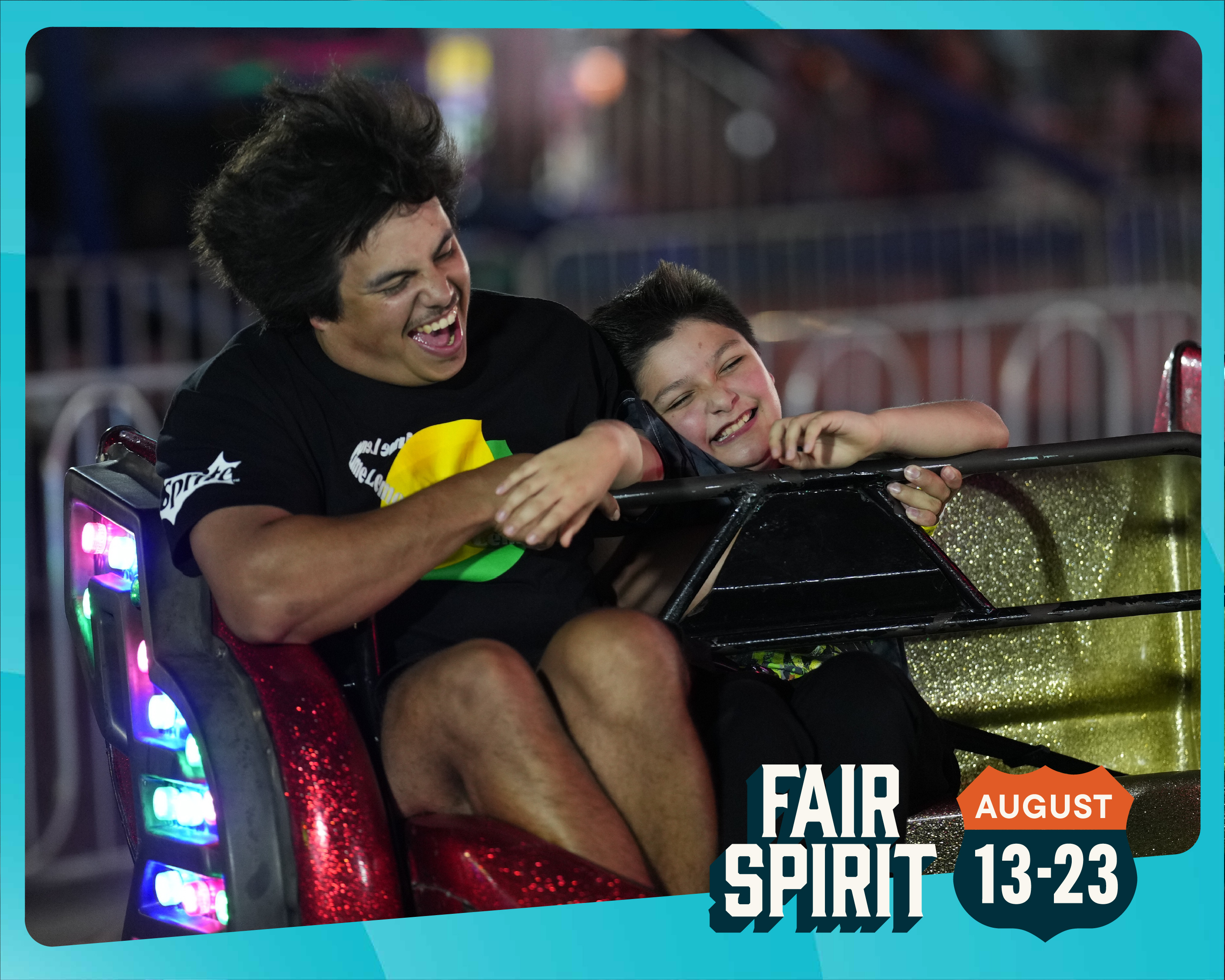 Two children riding a spinning ride in Thrill Ville during the Iowa State Fair. They're screaming and smiling.