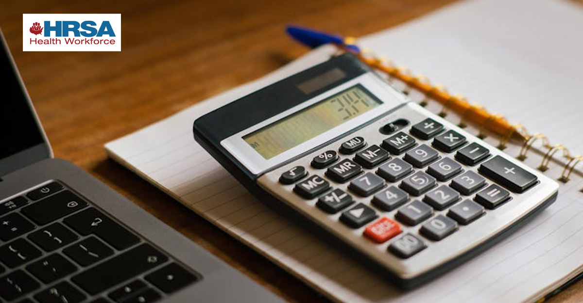 Calculator displaying 3.14 on a notebook beside a laptop on a wooden desk, with HRSA Health Workforce logo in the corner.