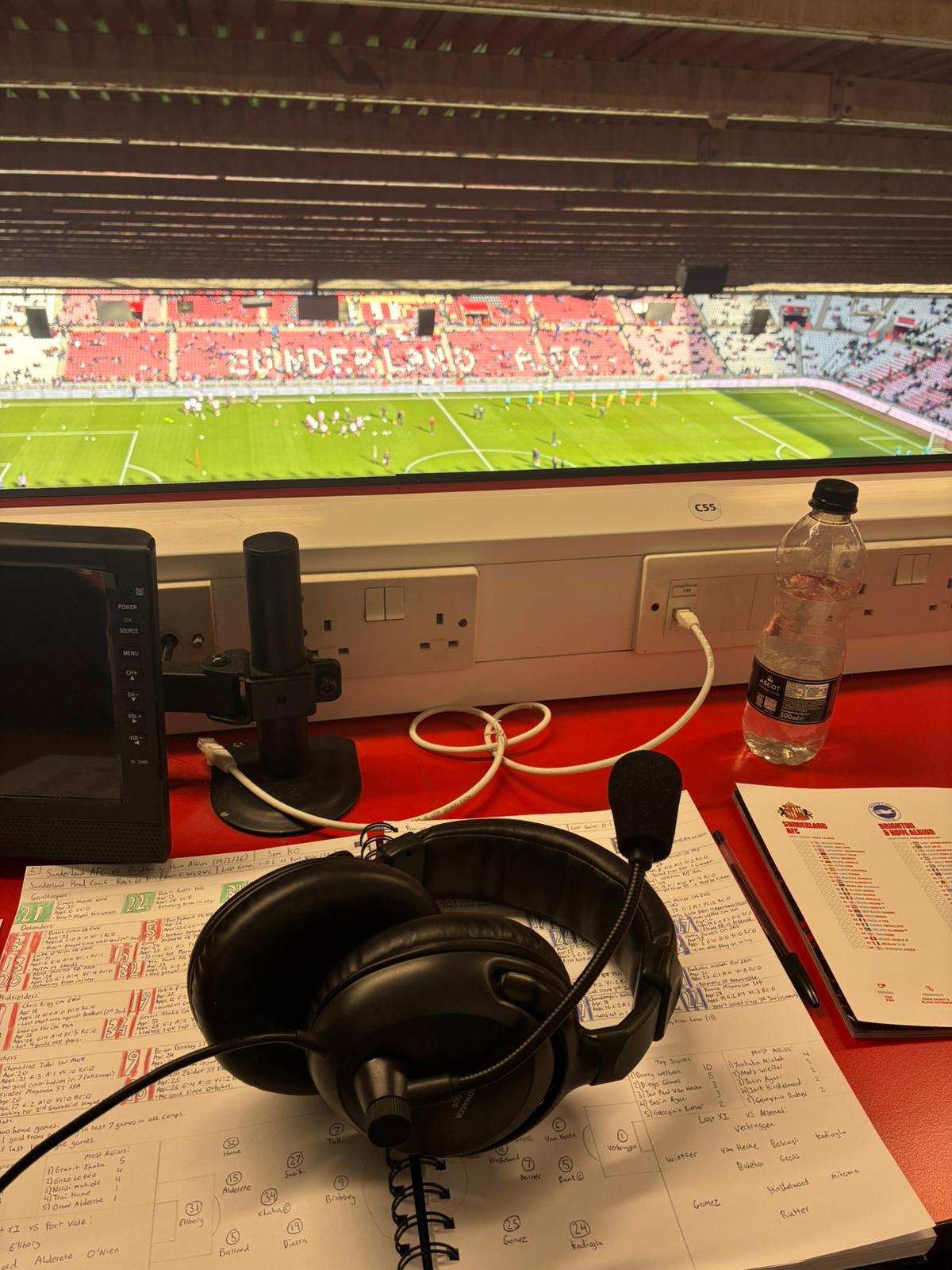 A head set mic sits on top of paperwork, overlooking the Sunderland pitch, from the media desks.