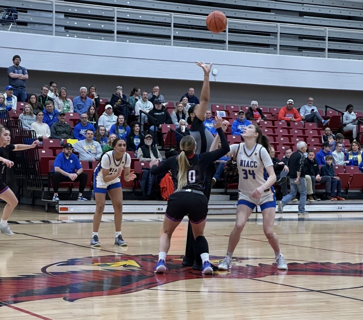 LLCC women's basketball team playing basketball.
