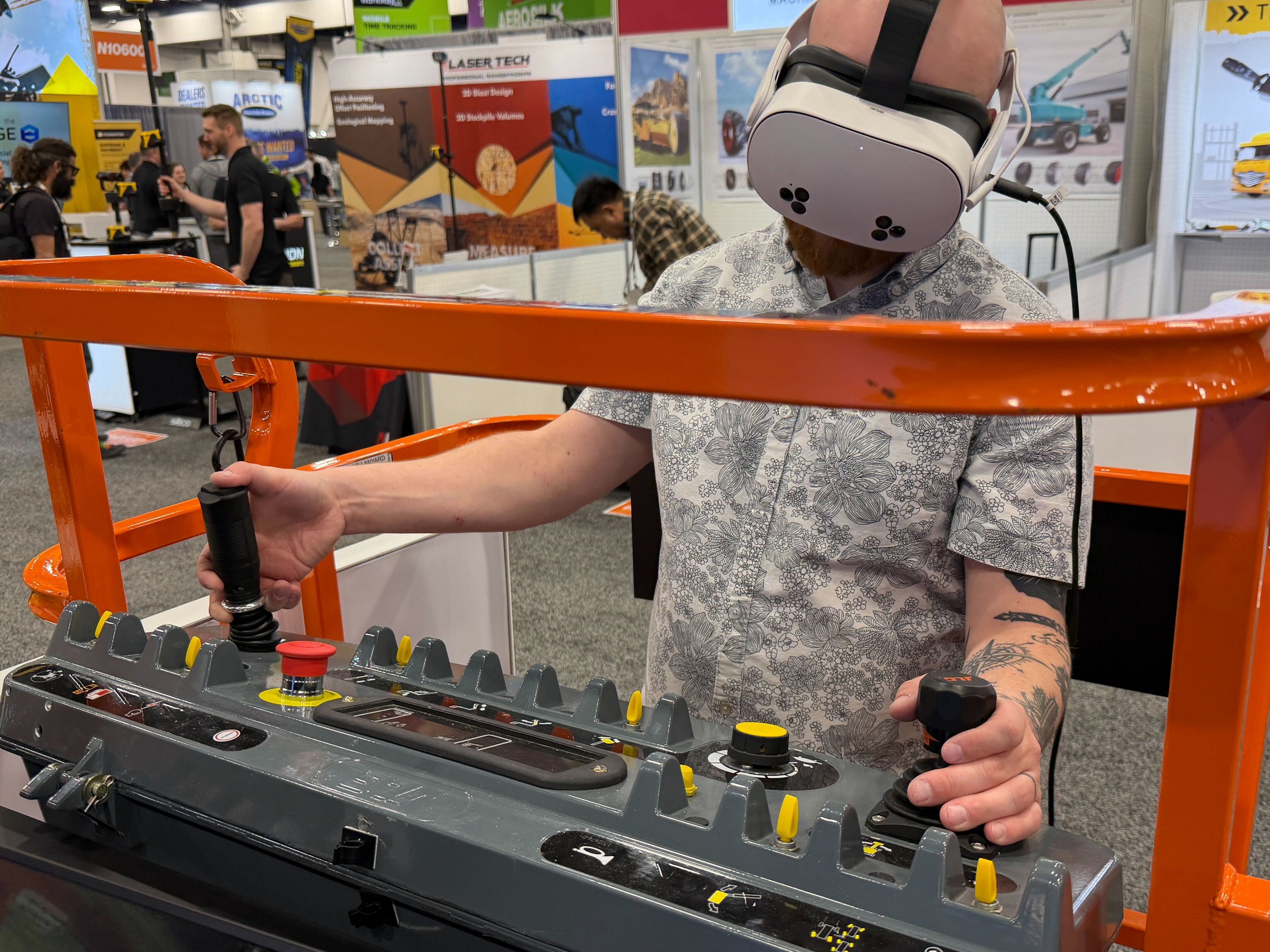 ForgeFX Simulations at CONEXPO-CON/AGG 2026: team members pose at the booth in front of a large video wall; CEO & Co-Founder Greg Meyers presents “From Iron to Impact” on the Ground Breakers Stage; attendees watch the session from white lounge seating; and visitors test immersive heavy equipment training demos using VR headsets and a bright orange lift simulator. Additional images show hands-on operator training, booth conversations, and live demonstrations of spatial computing-based training developed with partners including PICO XR. The photo set captures ForgeFX’s post-show highlights, customer engagement, and the company’s focus on safer, faster, and more measurable training for construction and industrial equipment operators.