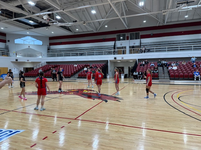 LLCC women's basketball team playing basketball.