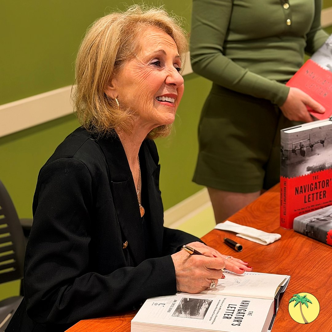 Jan Cress Dondi signing a copy of her book, "The Navigator's Letter."