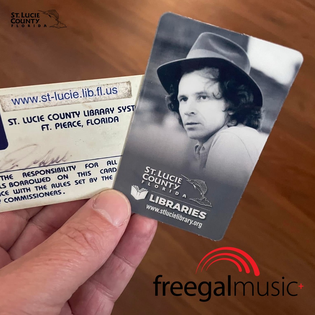 Hand holding two St. Lucie County Library cards, one showing a black-and-white photo of Gary Stewart and the other with library system details and website.