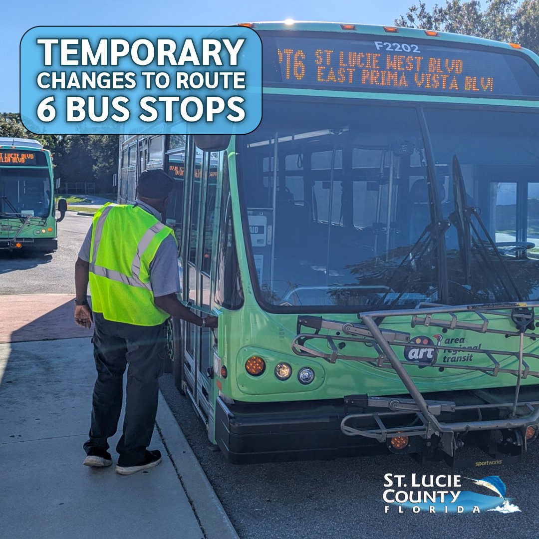 A transit worker in a neon safety vest inspects a green St. Lucie County bus at a stop under a sign announcing temporary changes to six bus stops.