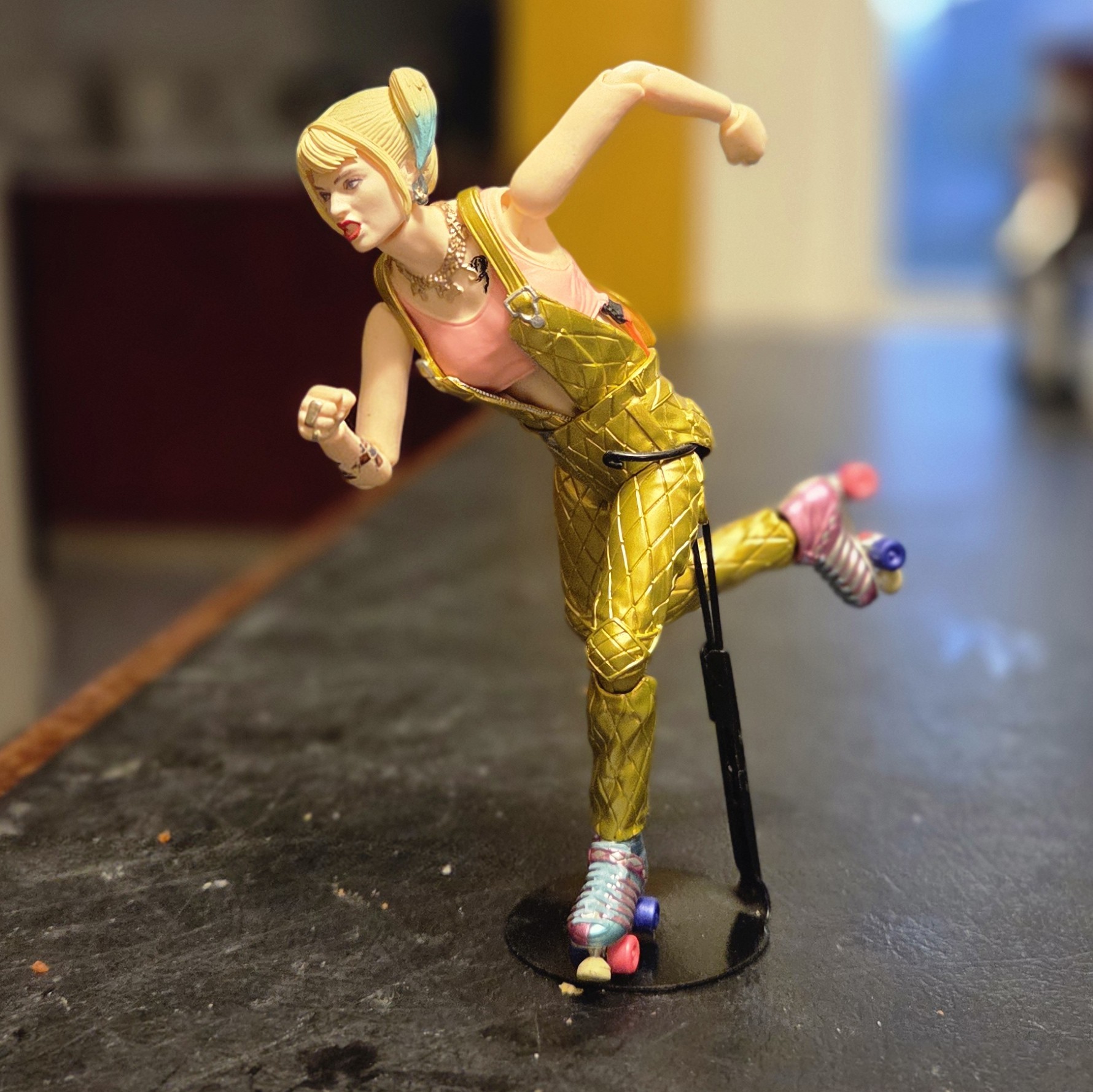 Harley quinn from birds of prey. Gold outfit on skates. in skating pose. Figure from MAFEX. 