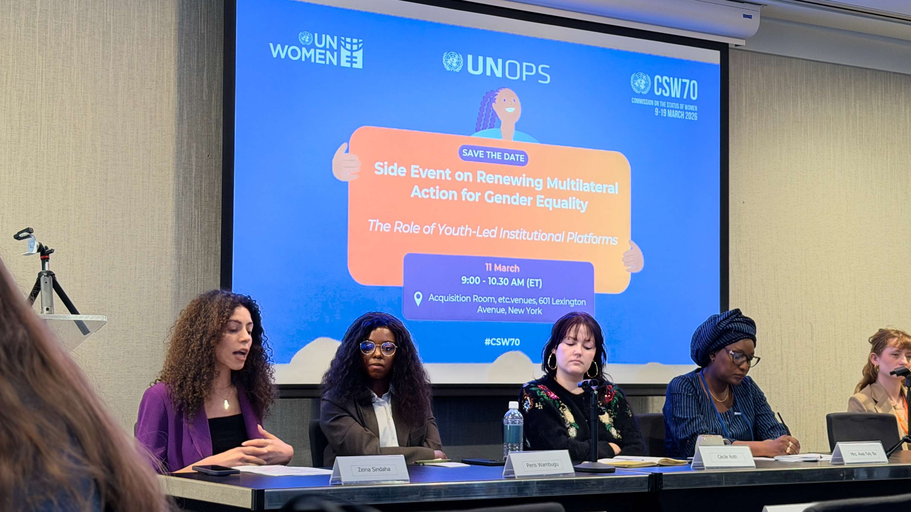 Panel of diverse women seated at a conference table during a UN event on gender equality and youth-led institutional practices.