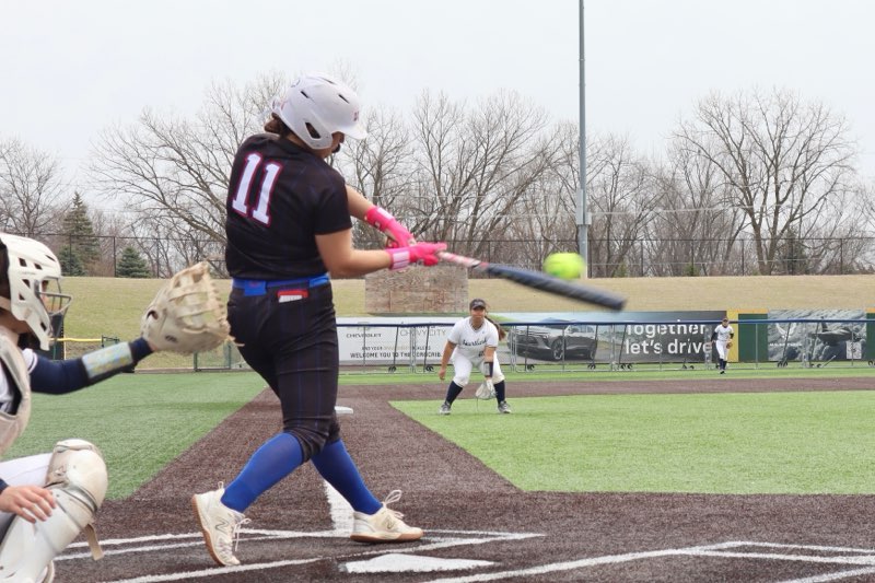 LLCC softball player hitting a ball.