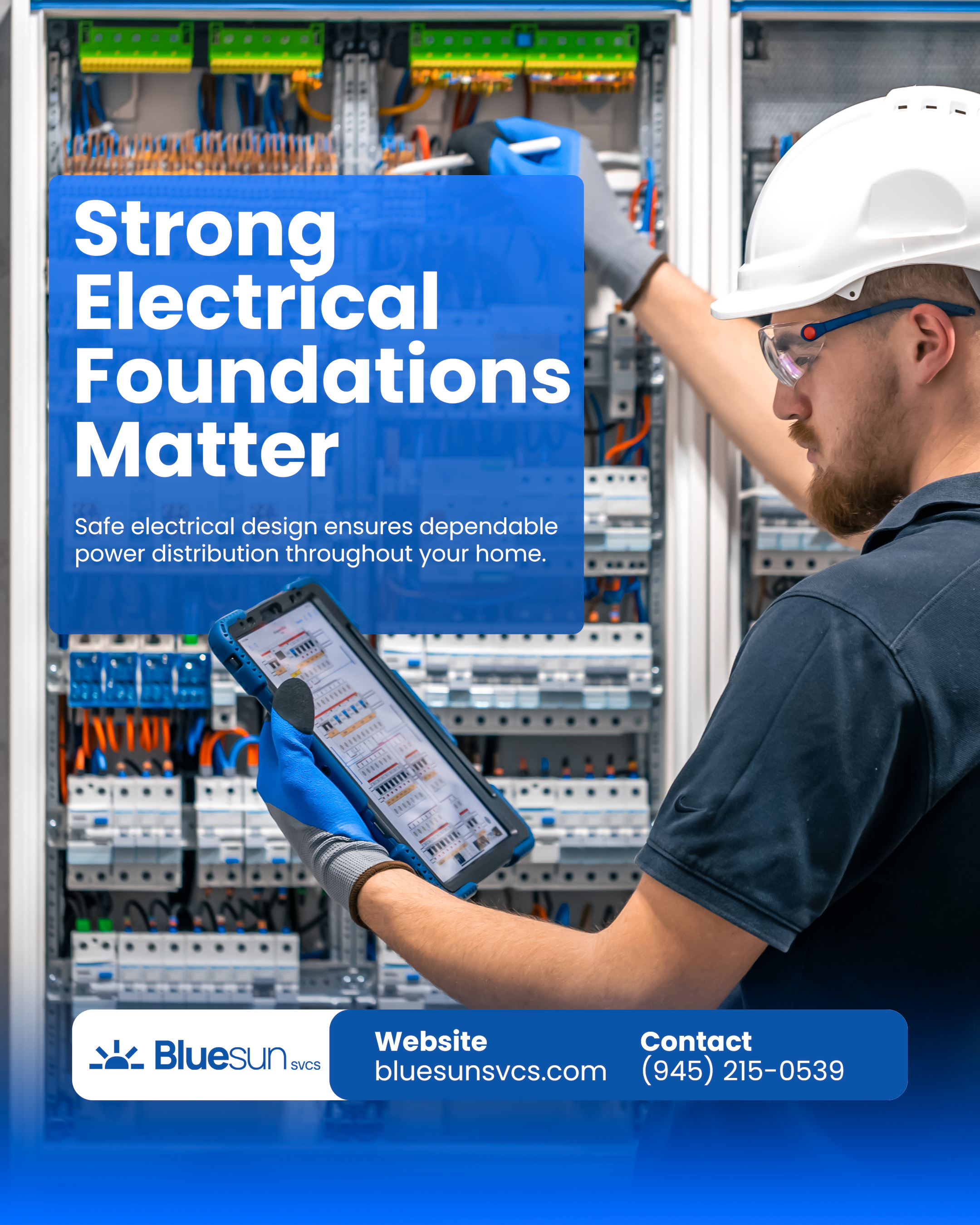 A professional electrician in a hard hat and safety glasses using a tablet to monitor and configure a complex residential electrical panel.