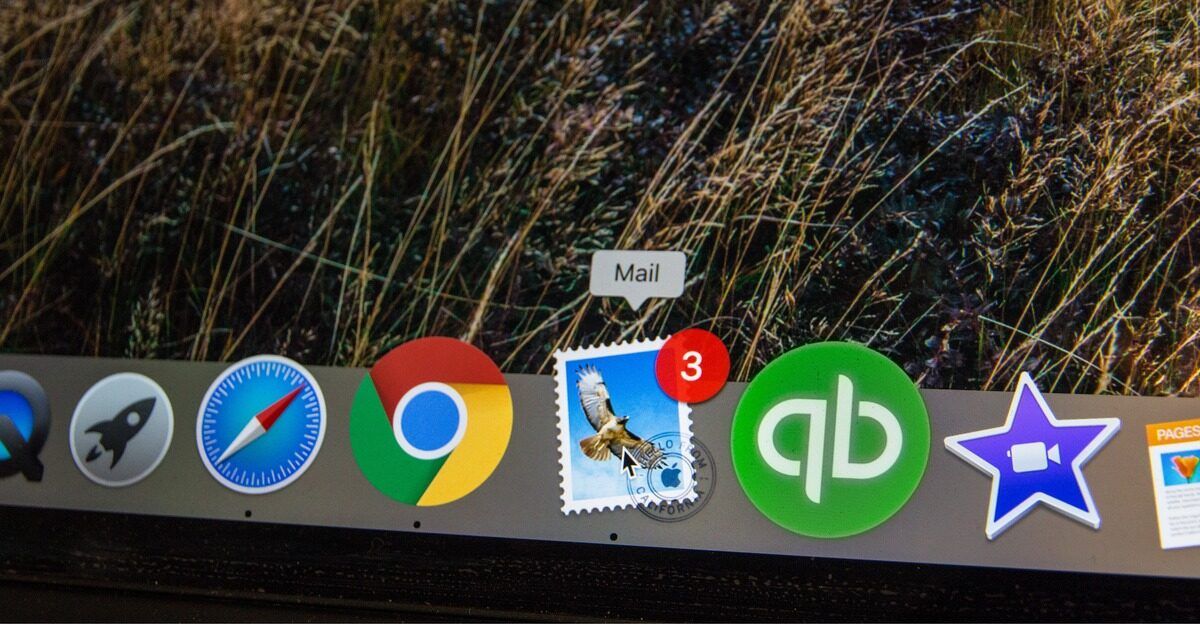 The dock of an Apple computer screen is seen, with the Mail email application signaling three new emails.