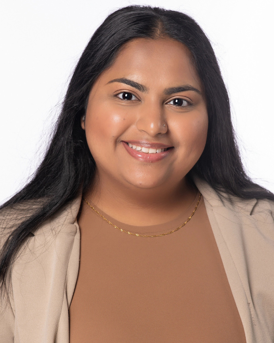 Head shot of Sayeda Ali, wearing tan blazer with light brown shirt.  White background.