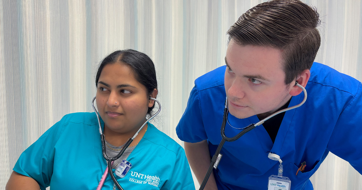 Sayeda Ali wearing teal scrubs and a professor wearing blue scrubs practice using stethoscopes  in a clinical setting. Their scrubs feature a logo for UNT Health College of Nursing.