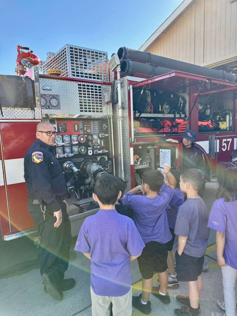 A cow fire firefighter showing the engine pump panel of engine 57