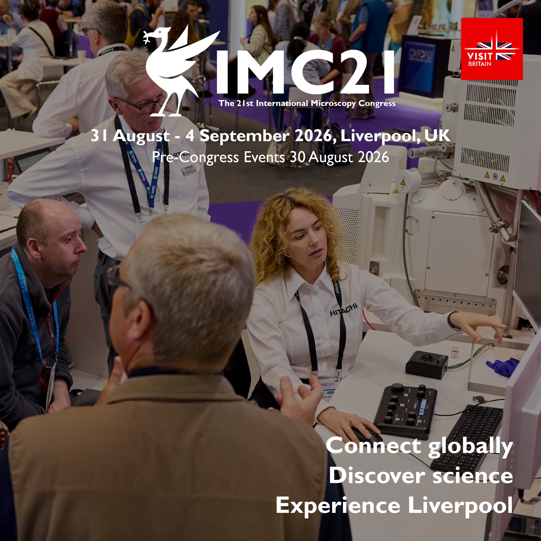 Scientists and attendees engage around microscopy equipment at IMC21 in Liverpool, August-September 2026.