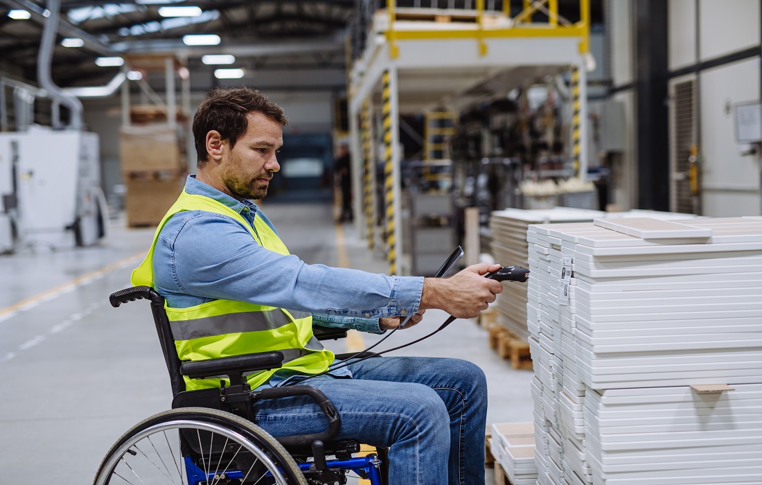 Wheelchair user working in a warehouse