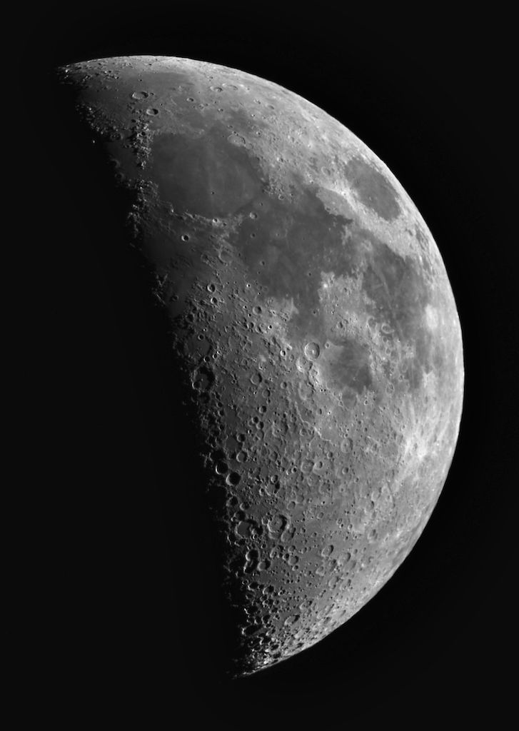 A telescopic photograph of a First Quarter Moon showing well defined craters along the terminator.