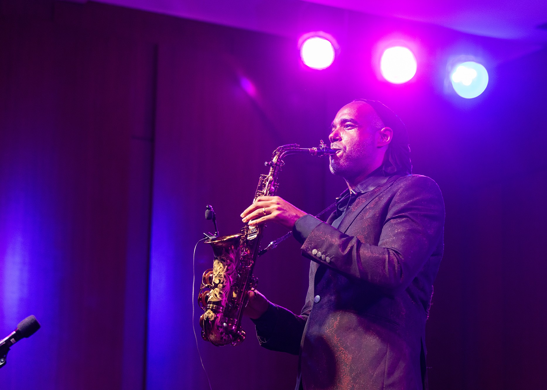 Marcus Miller plays music with a saxophone