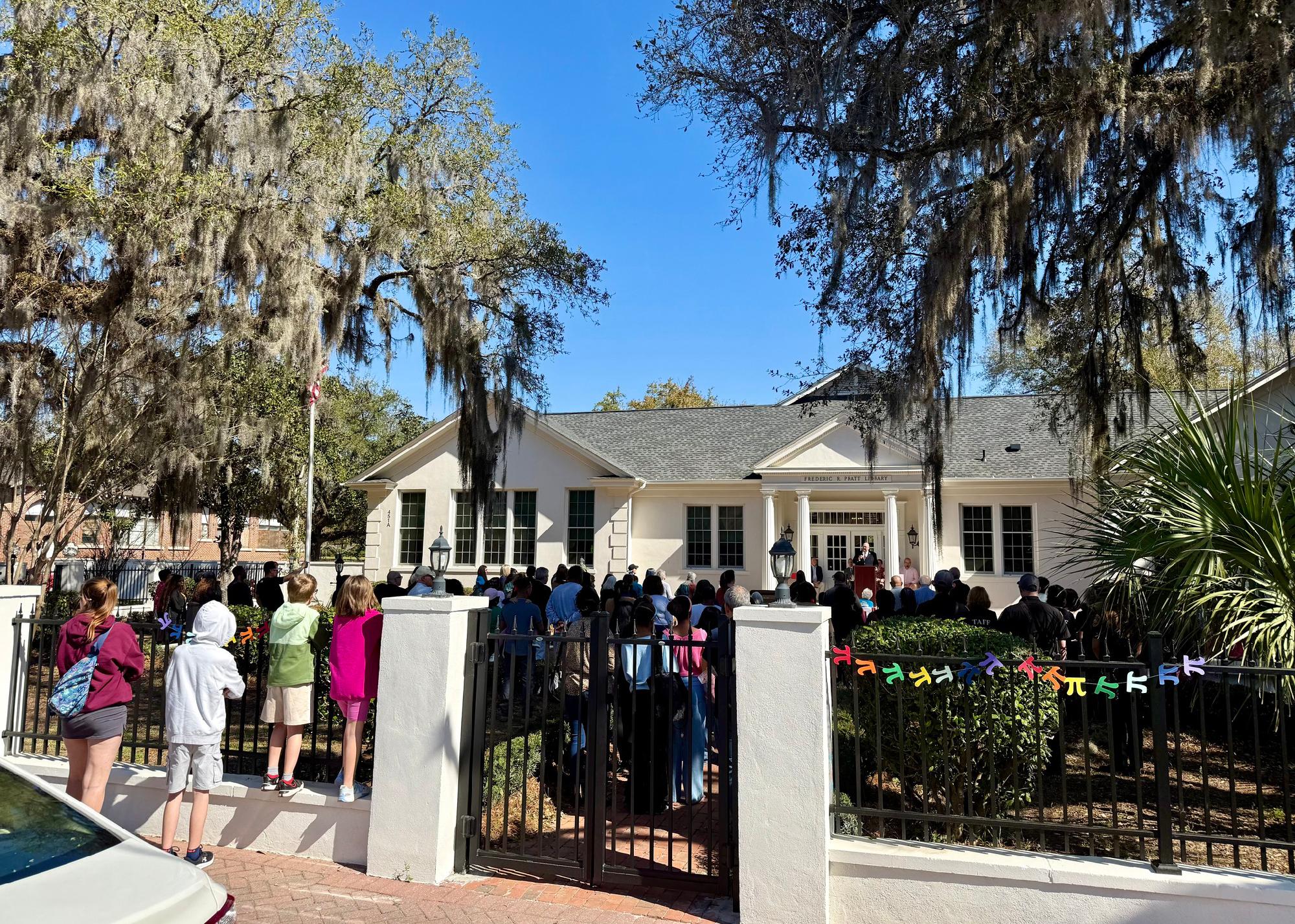 People gathered in front of a library