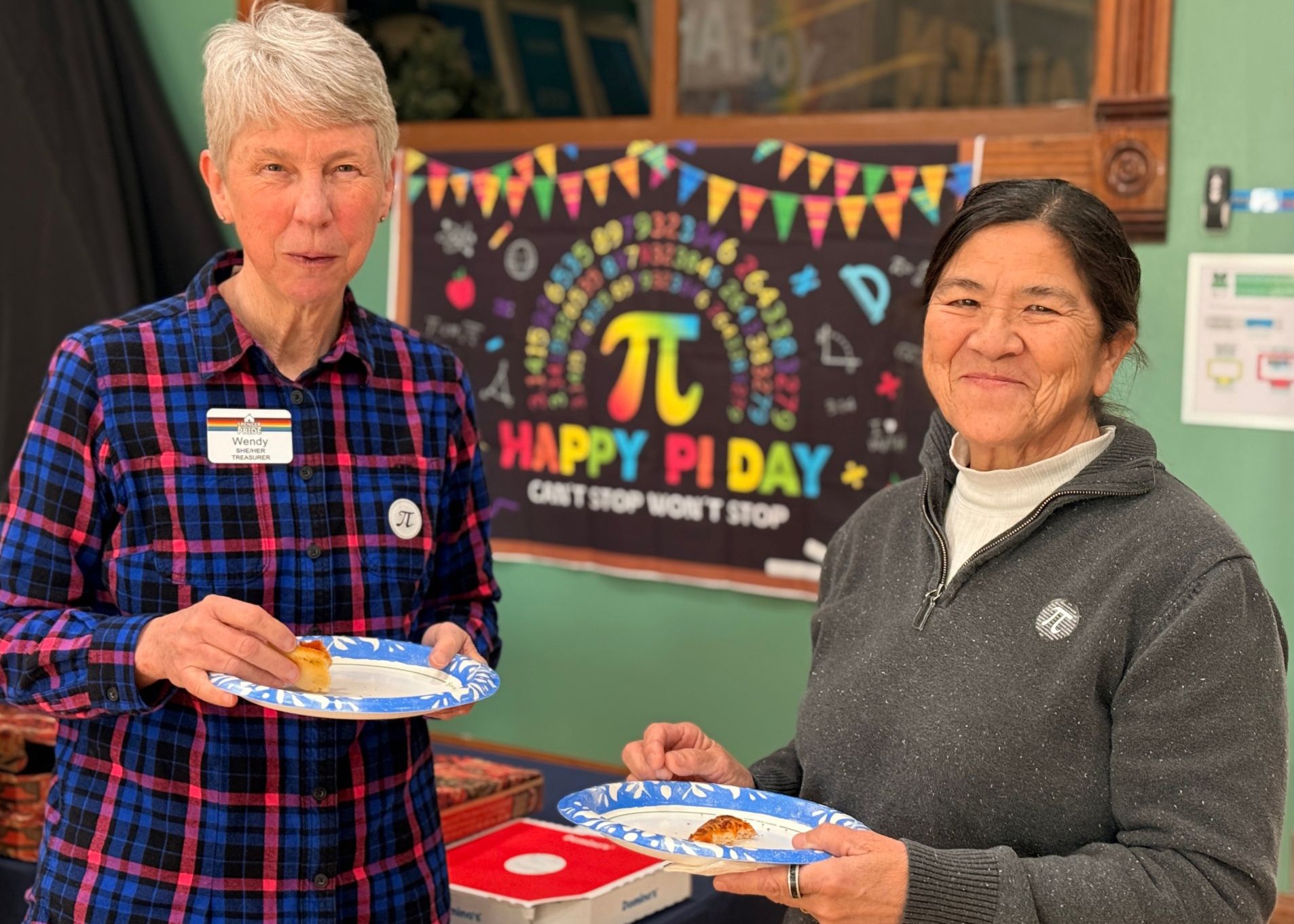 Two people smile for a photo