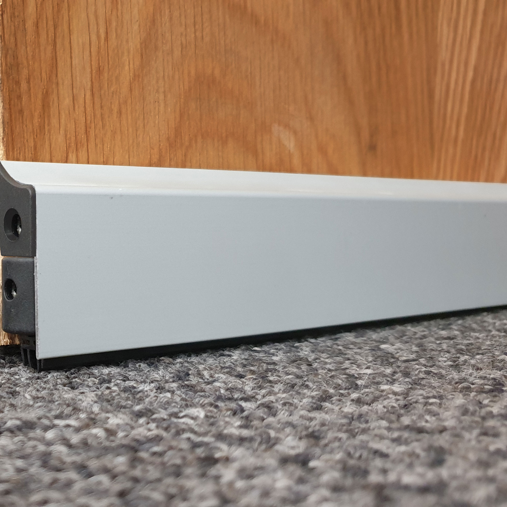 Surface Mounted door bottom seal - drop down type.
Aluminium body with rubber coextruded seal and carrier.