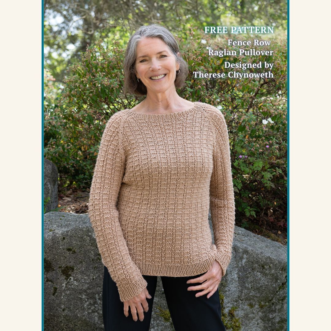 A person is standing outside wearing the Fence Row Raglan Pullover, a Cascade Yarns free pattern, designed by Therese Chynoweth.
