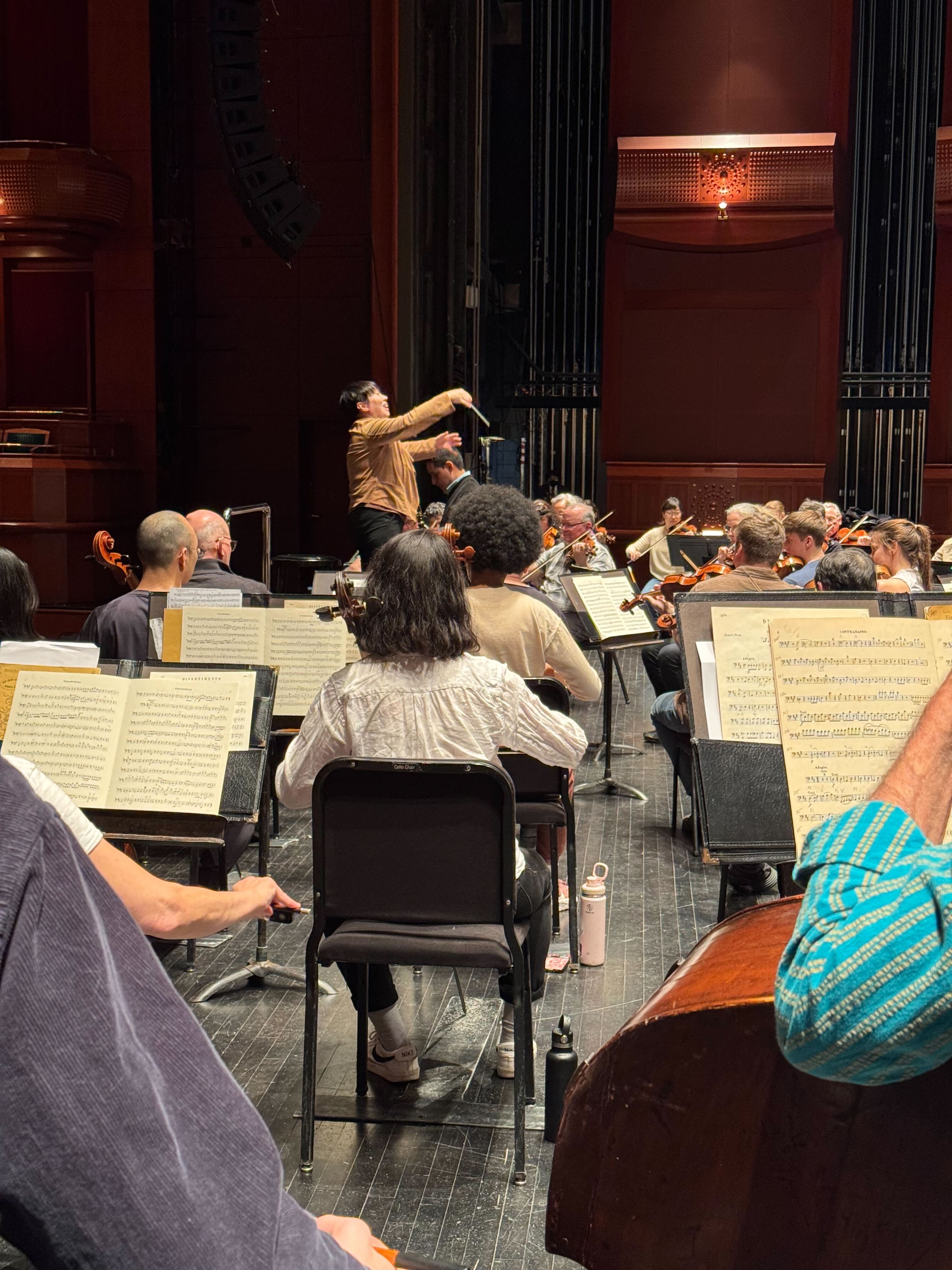 Music Director Xian Zhang conducting New Jersey Symphony musicians with her baton during rehearsal.