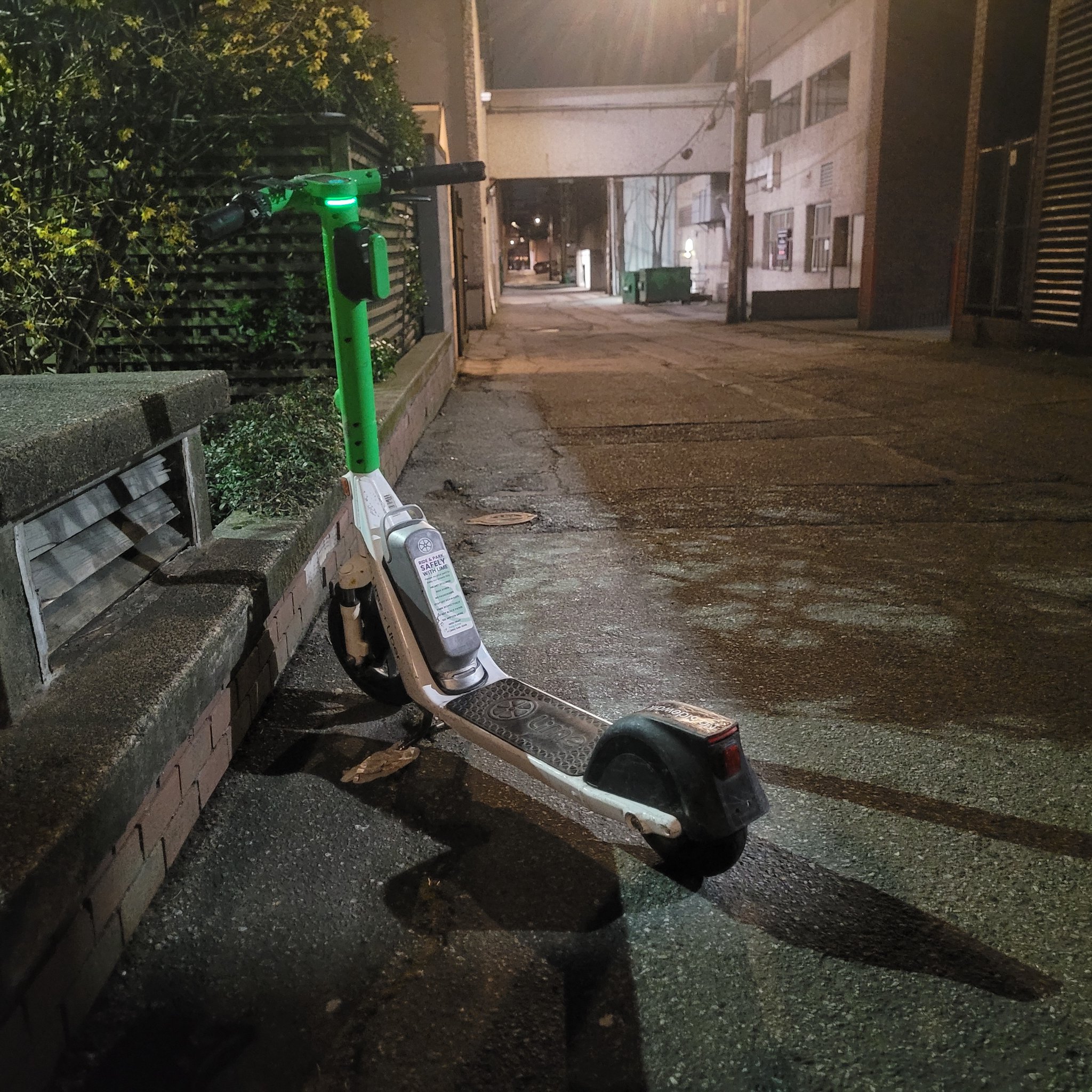 Another Lime e-scooter in an alley, just metres from the Alder St dock sits abandoned.