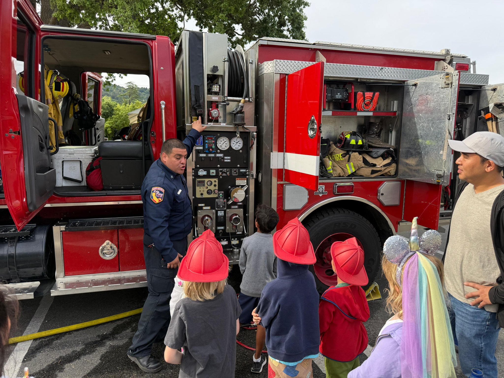 (CAL FIRE) fire captain showing the engine pump panel of the fire engine