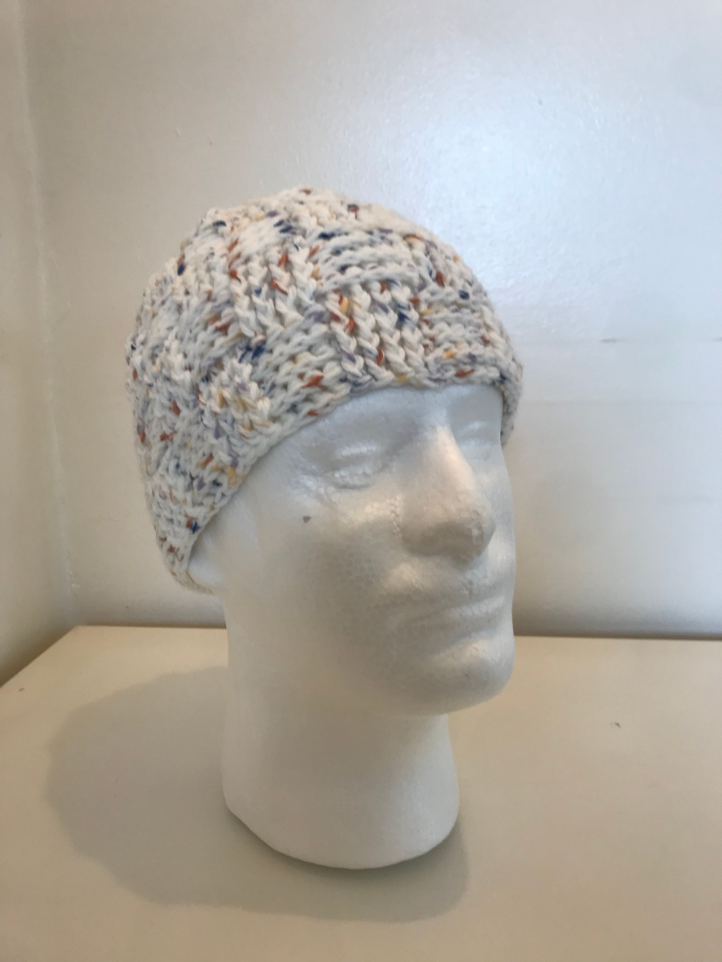 A handmade chunky crochet beanie hat made from soft speckled acrylic yarn, designed with textured stitches for warmth and comfort.