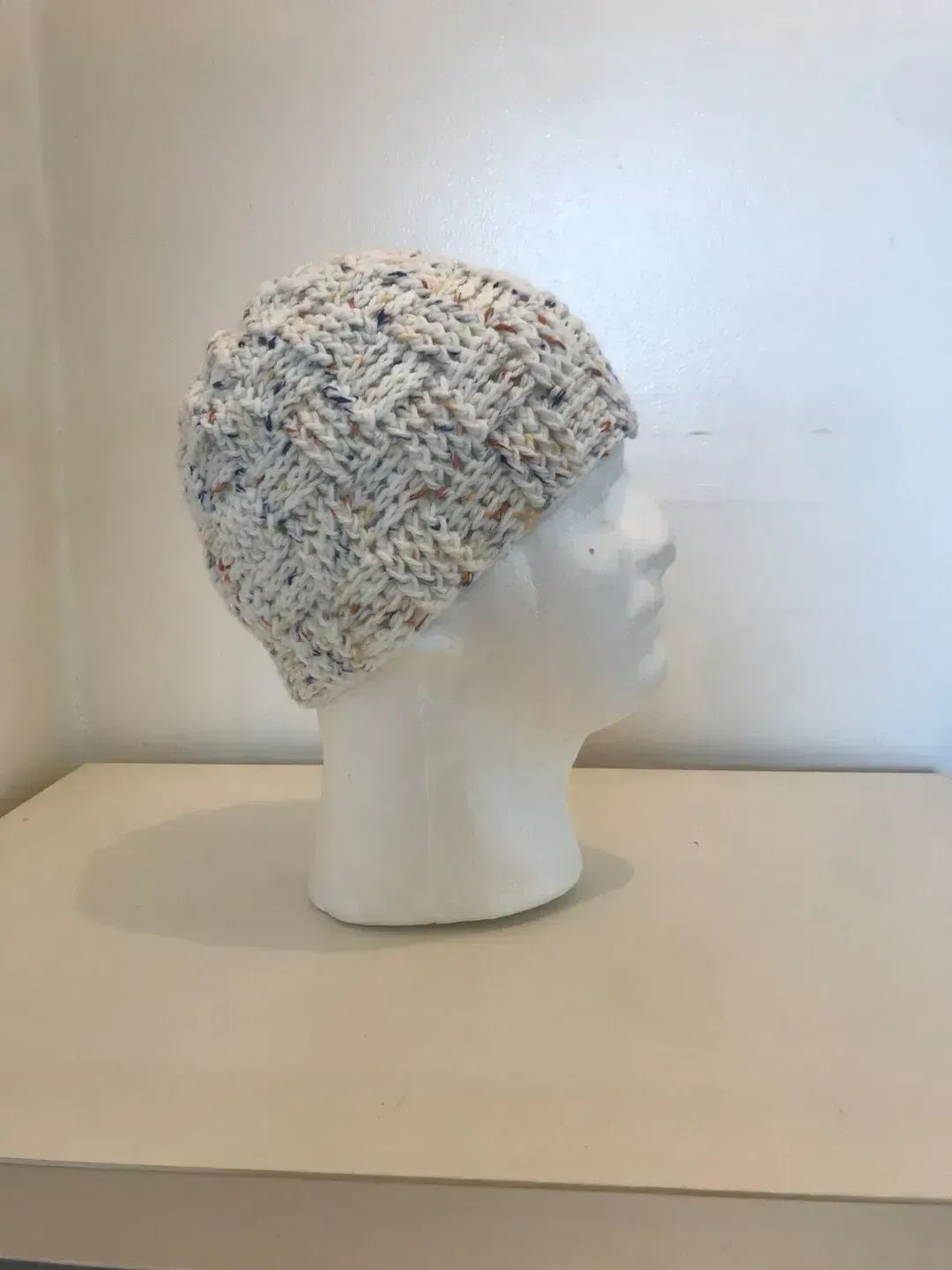 A handmade chunky crochet beanie hat made from soft speckled acrylic yarn, designed with textured stitches for warmth and comfort.