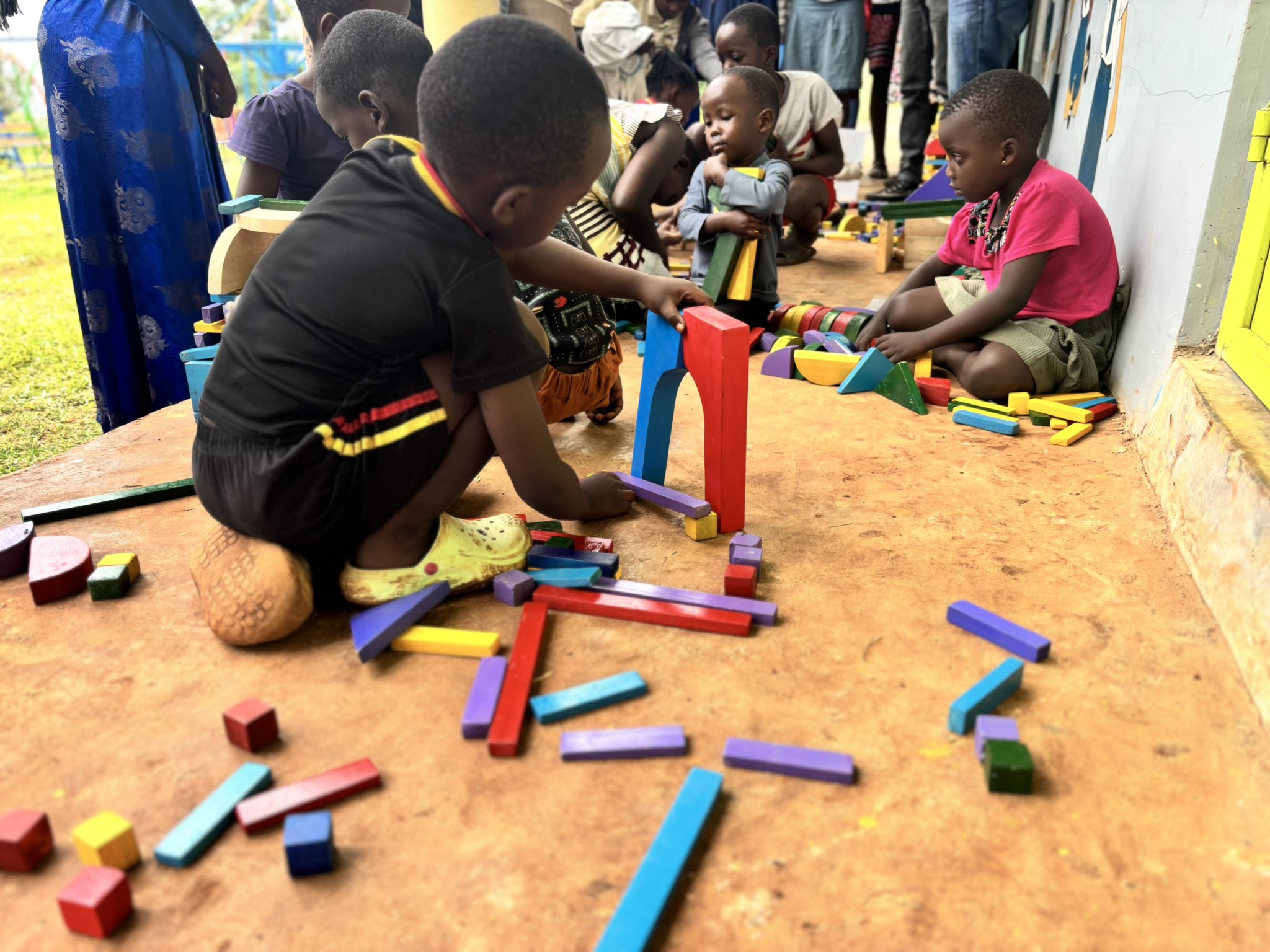 A child playing with Ajibu Community blocks. Deep focus and concentration being observed.