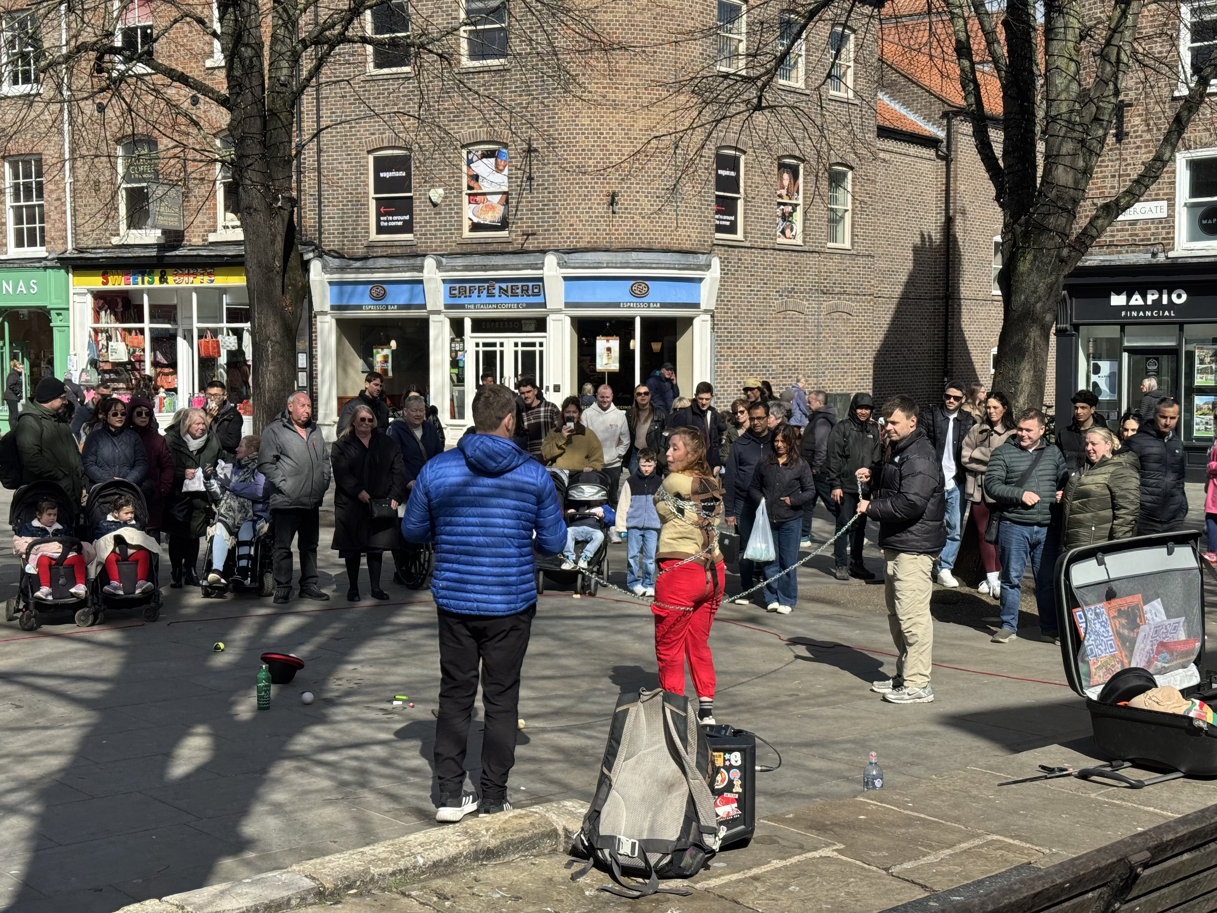 Performer getting tied into a straight jacket and chains.