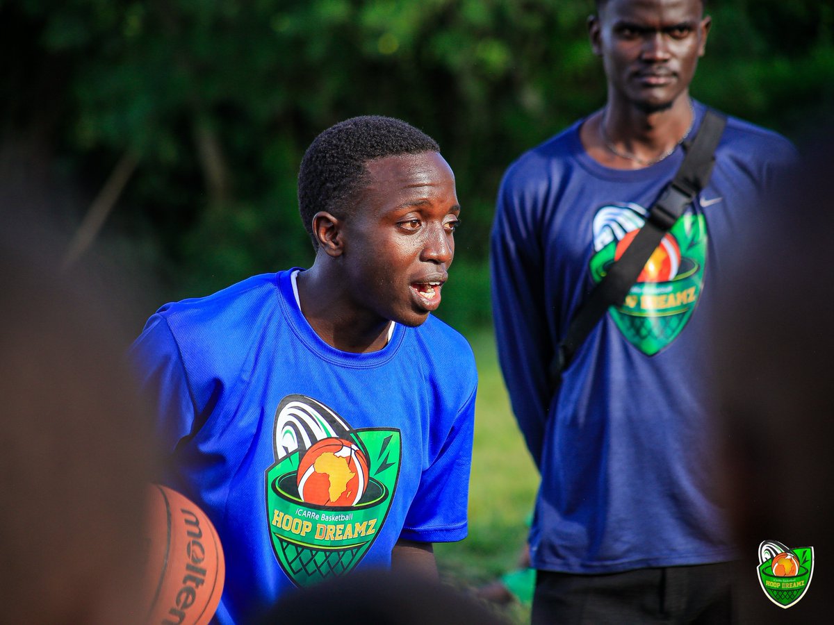 iCARRe Coaches Kasule Ibrahim (Holding a Basket ball) and Kyazze Benjamin training the students