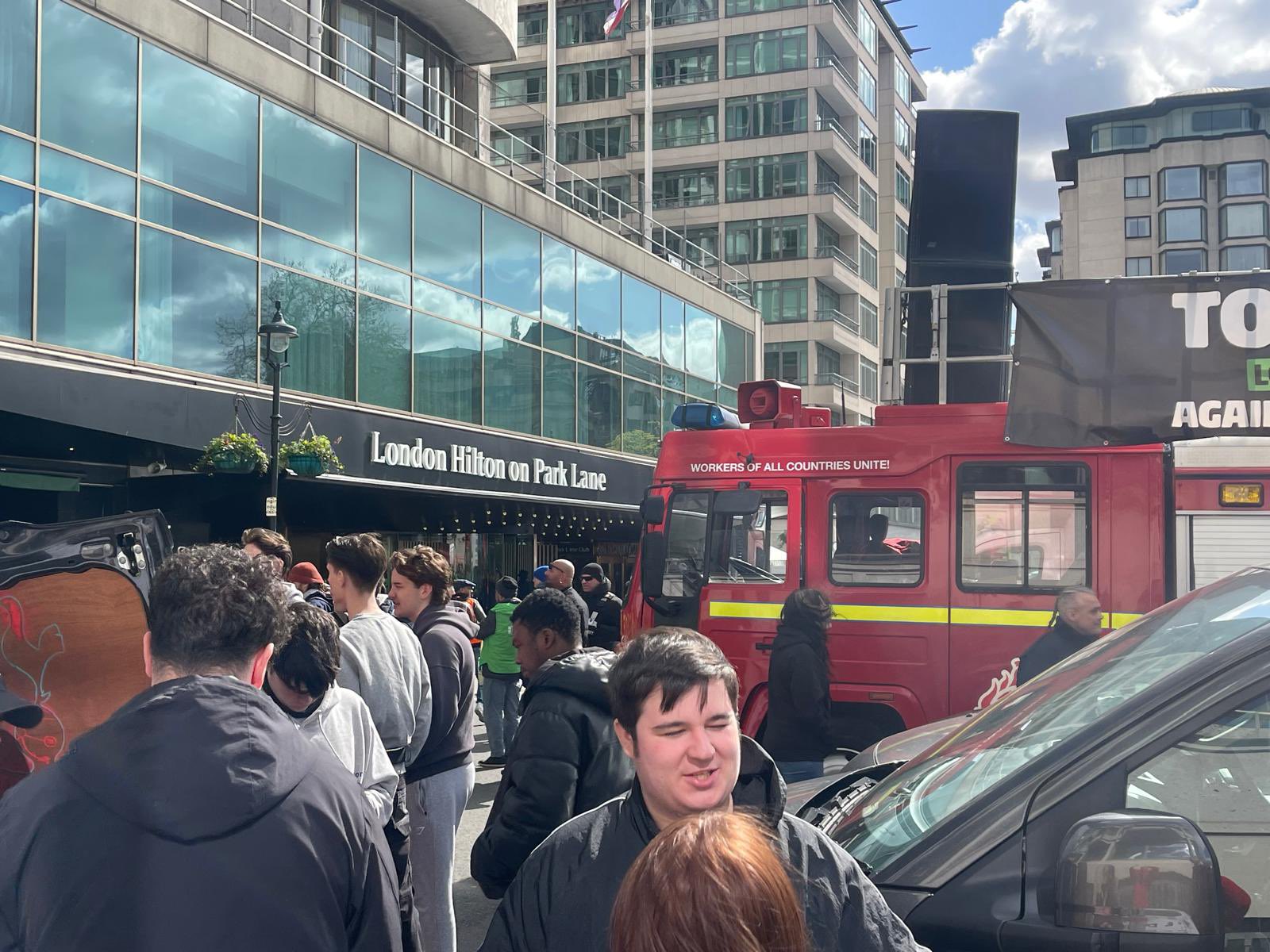 Activists are gathered outside london Hilton hotel park lane where the red fire engine is parked for speeches