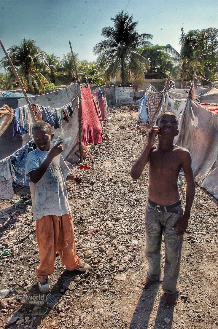 Two boys in a squalid, makeshift camp in Bon Repos, Haiti. 2010. Gary Moore photo. Real World Photographs. #world #poverty #Haiti #Nikon #photojournalism  #garymoorephotography #realworldphotographs #Copenhagen #Malmo #Europe