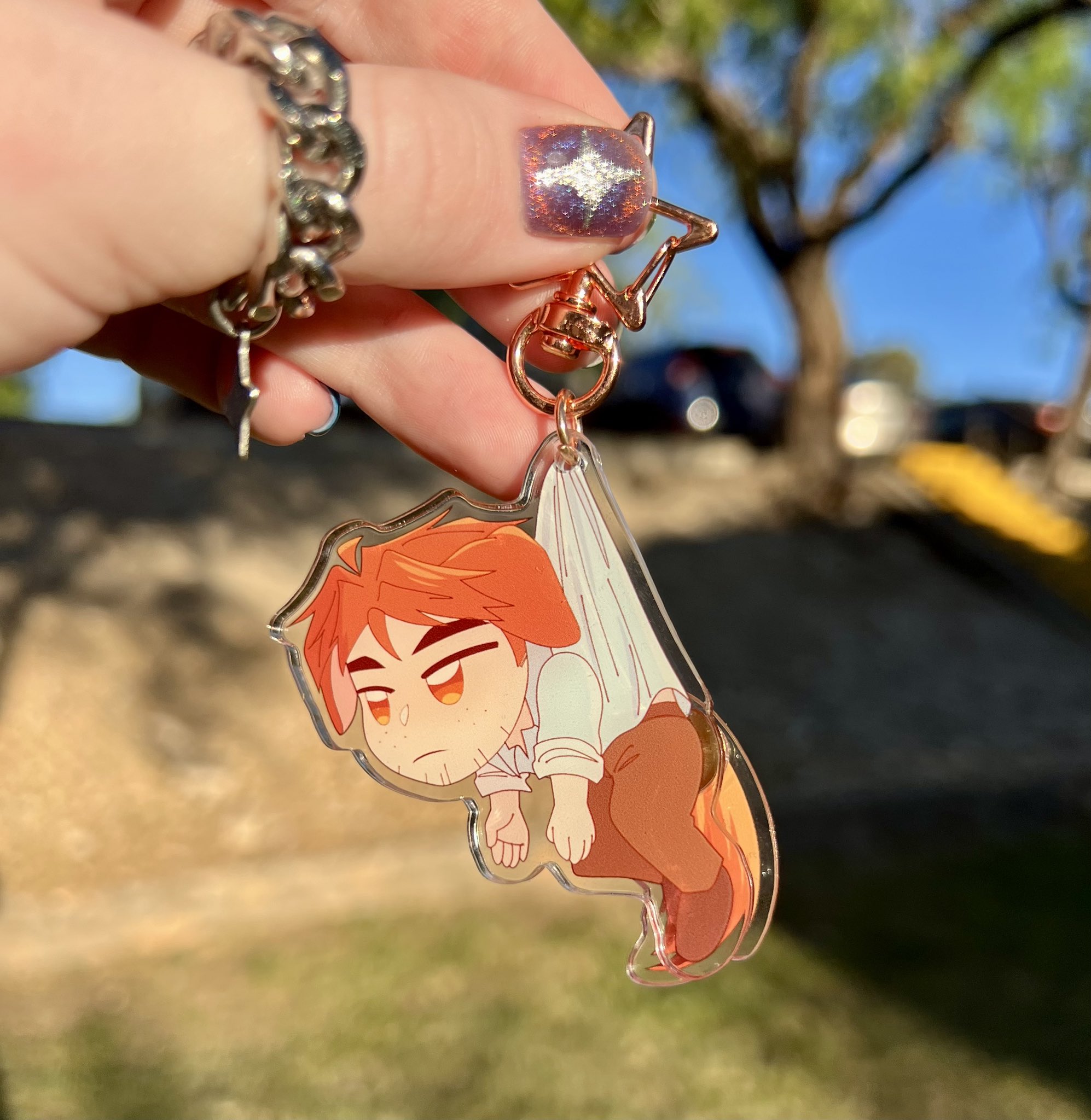 A keychain of Robert from Dispatch with dog ears and a tail that wags!