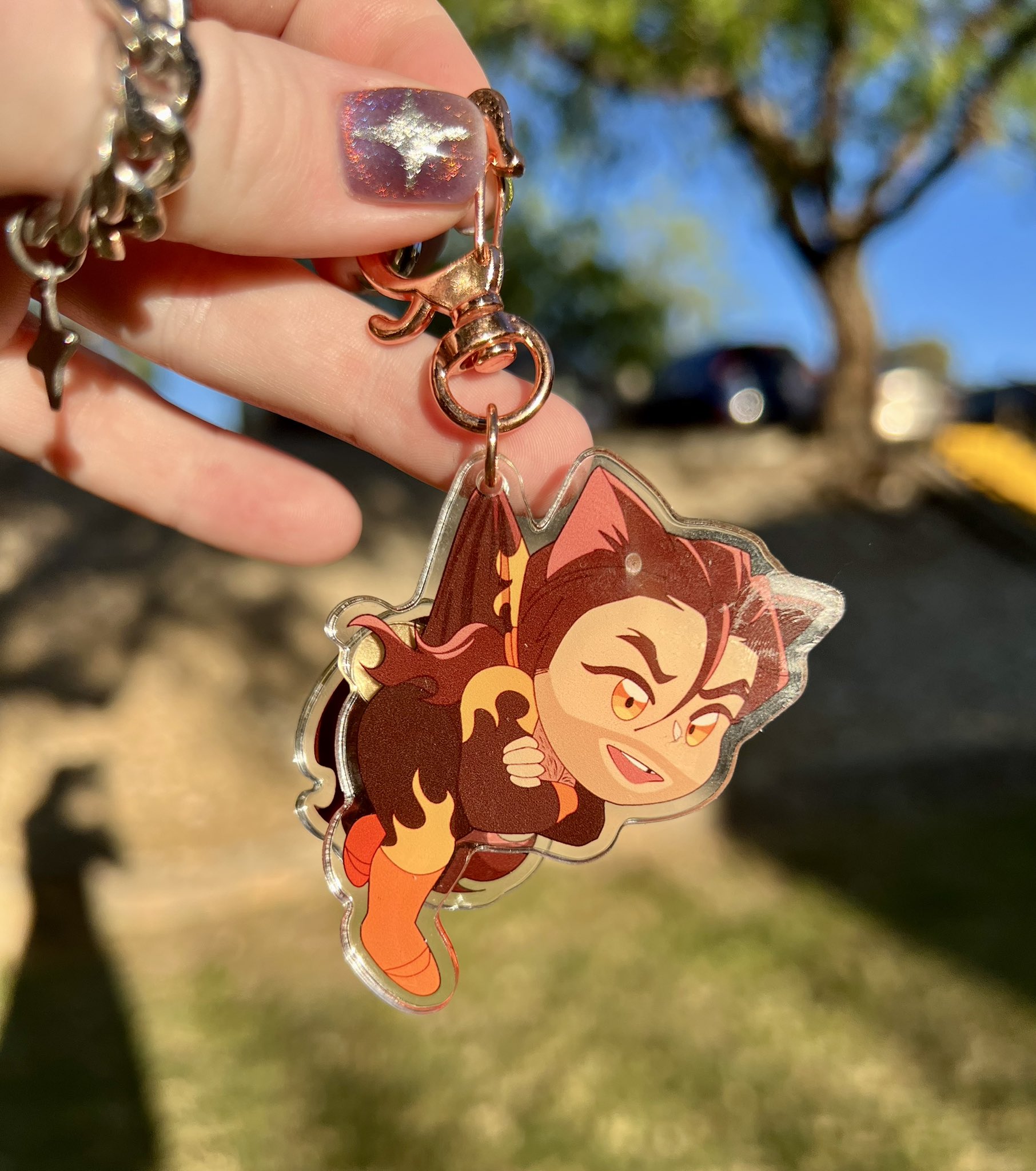 A keychain of Falbae from Dispatch with cat ears and a tail that wags!