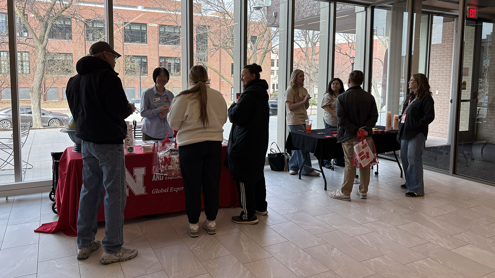 five visitors talk to representatives from CEHS global experiences and learning communities