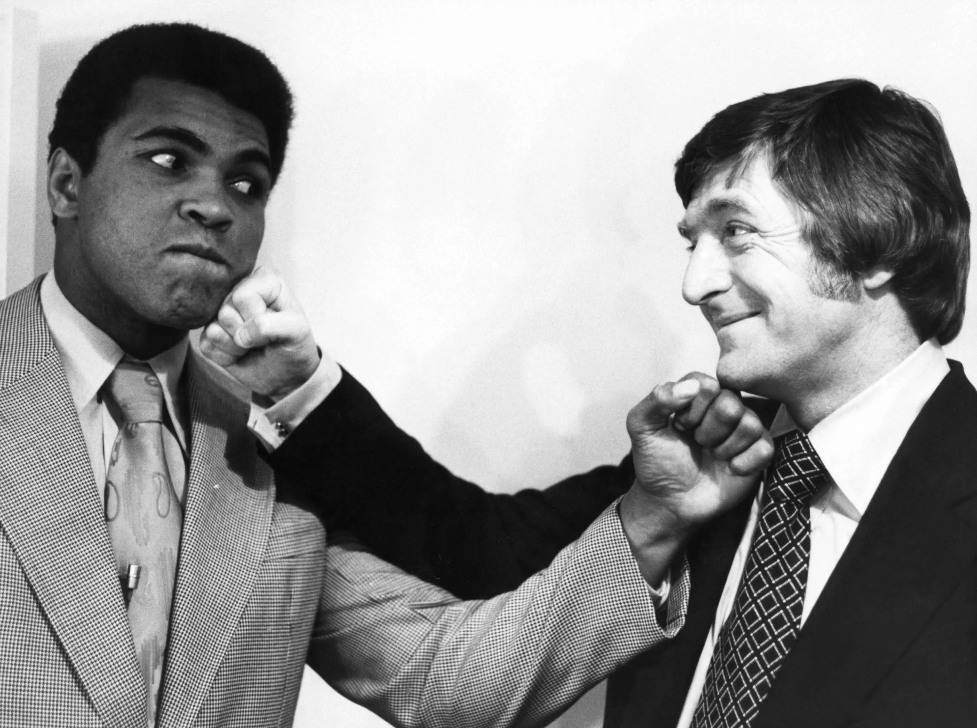 Sir Michael Parkinson on the right posing with Mohammed Ali.