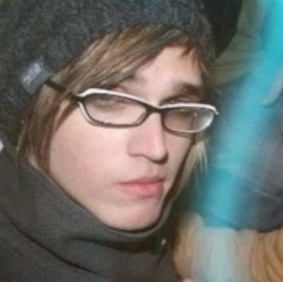 green plastic watering can for a fake rubber plant