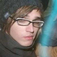 green plastic watering can for a fake rubber plant